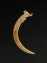 A claw-shaped curved flat jade object, almost C-shaped, with an animal carved into it.　