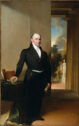 Formal portrait of an older gentleman dressed in nineteenth-century black suit with tails and white shirt, looking at the viewer.