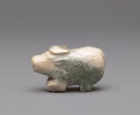 A 3D sculpture of a buffalo that is round in shape and off-white and dark green in color. The buffalo is facing the left. The buffalo has a small, round snout and horns. The body of the buffalo has curved engraved lines. The buffalo’s rear is wide and round.