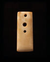 An axe blade of carved ivory colored jade