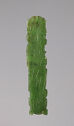 A jade tablet that is long and narrow in shape and bright green in color with some dark green coloration. There are carved lines throughout the piece that outline curved figures. The edges of the tablet are irregular and flat.