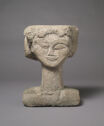 A sculpture of a head carved from a single block of stone.