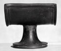 A curved black clay stand and tapered base