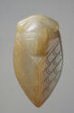 A jade sculpture of a short, round cicada. The top is curved with carved lines to detail the head and antennas. The middle and bottom have carved curved, detailed lines that make downward facing points. The bottom comes to a point. It is light yellow and cream colored.