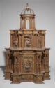 Ornate, gilded four-tiered wooden altarpiece with carved decoration.