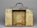 A gilt bronze square box with two doors that open to an image of a seated man surrounded by other people.
