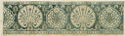 A long rectangular piece of fabric with unfinished side edges and a small geometric border at the top and bottom. The fabric’s background is a light yellow color and the pattern is teal. There are four and a half large alternating floral motifs along the center of the fabric. There are two fan-shaped motifs with smaller flower stems inside them and two and a half large, curved blossom motifs. They are surrounded by smaller floral details.