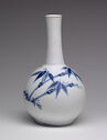 A white porcelain bottle with blue painted decorations on either side
