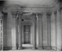 A black and white photograph of an empty ornate room.
