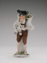 Hand painted porcelain figure of a young man holding a baby goat in his left arm.