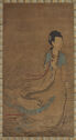 A dark tan, rectangular painted scroll depicts a woman dressed in a white and blue robe to the right. Her robes flow as if blown by wind towards the left. Small waves surround her feet and behind her.