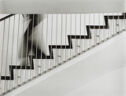 A blurred figure walking down a staircase