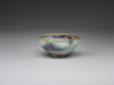 A small pale teal bowl with swirls of purple glaze.