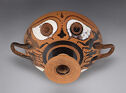 A two-handled bowl seen from below which is decorated with two large eyes.