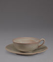 A glazed stoneware cup and saucer.