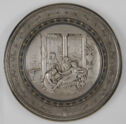 Circular decorative plaque with a relief of three woman tending to a reclining fourth woman in a classical scene. 