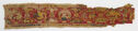 A long, rectangular textile fragment with a red ground and animal figures woven in yellow with black, green, blue, and pink details. 
