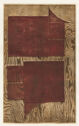 Blocks of dull red printed on a sheet of brown wood grain pattern