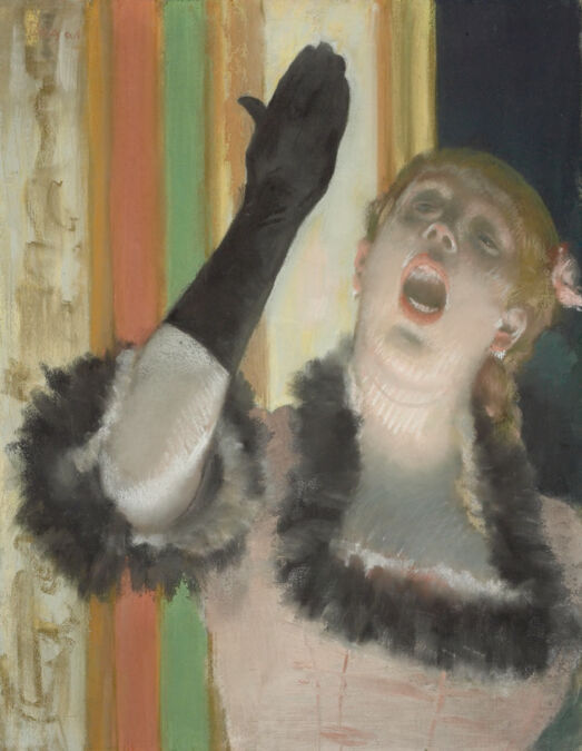 Dramatic portrait of a singing woman, in mid-note, raises her right hand wearing a long black glove.