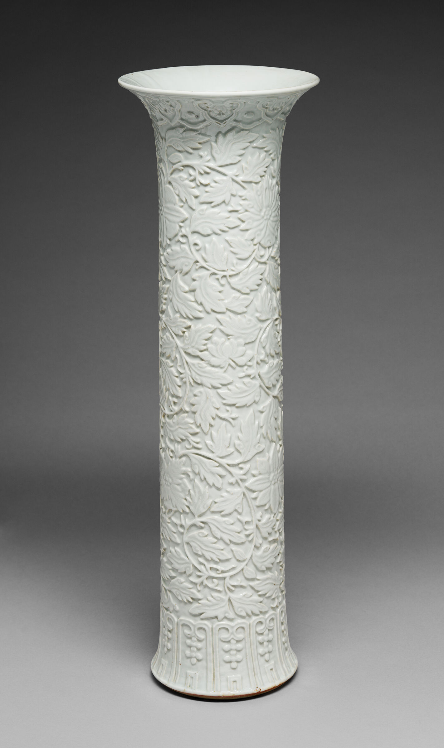 One Vase From A Garniture Set: Tall Cylindrical Vase With Flaring Lip And Subtly Flaring Foot And With Decoration Of A Scrolling Vine With Fruiting And Flowering Branches