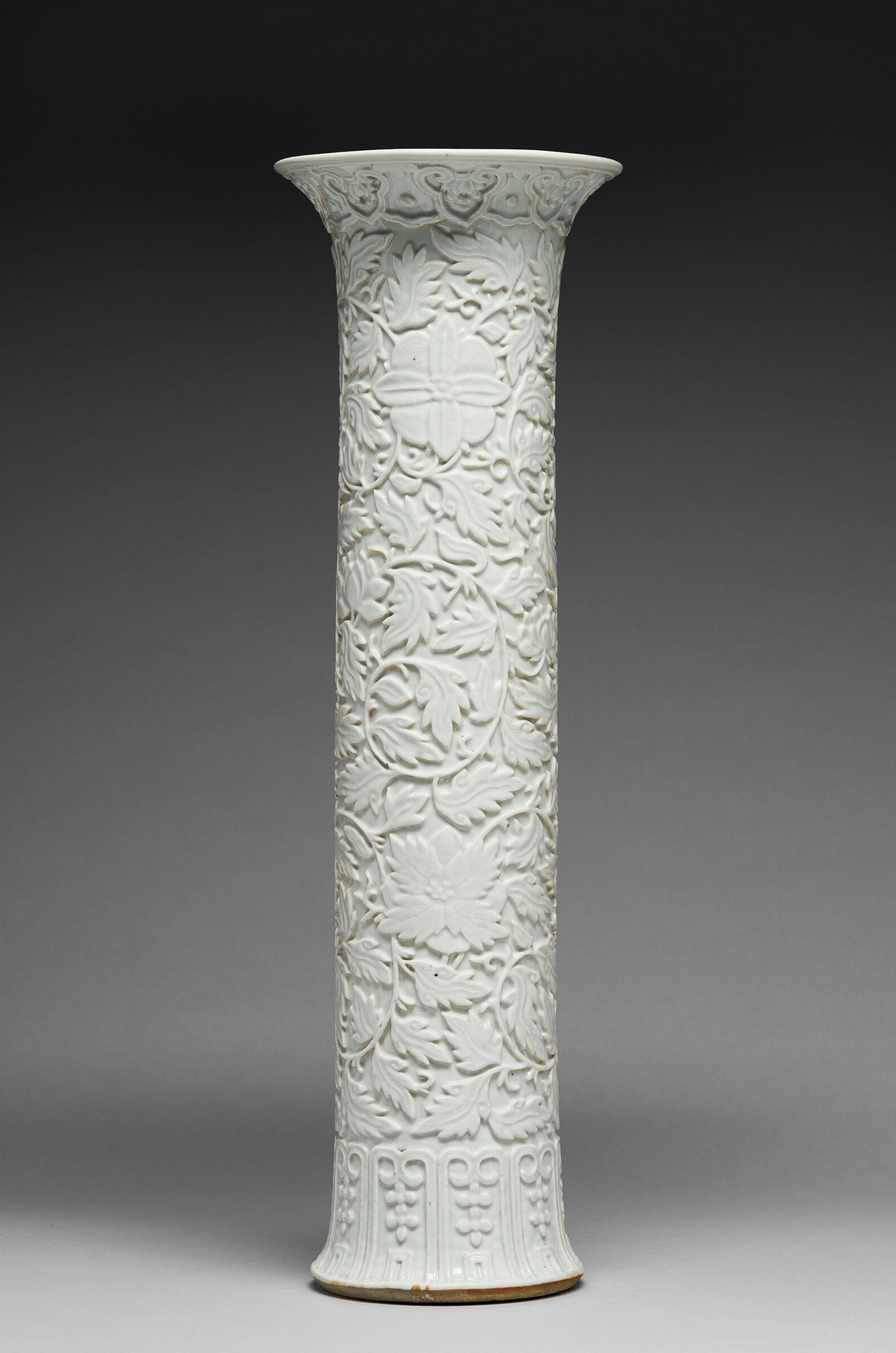 One Vase From A Garniture Set: Tall Cylindrical Vase With Flaring Lip And Subtly Flaring Foot And With Decoration Of A Scrolling Vine With Fruiting And Flowering Branches