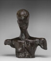 
Bronze bust of a man with a long, narrow head, broad shoulders, and a slim upper torso. 
 