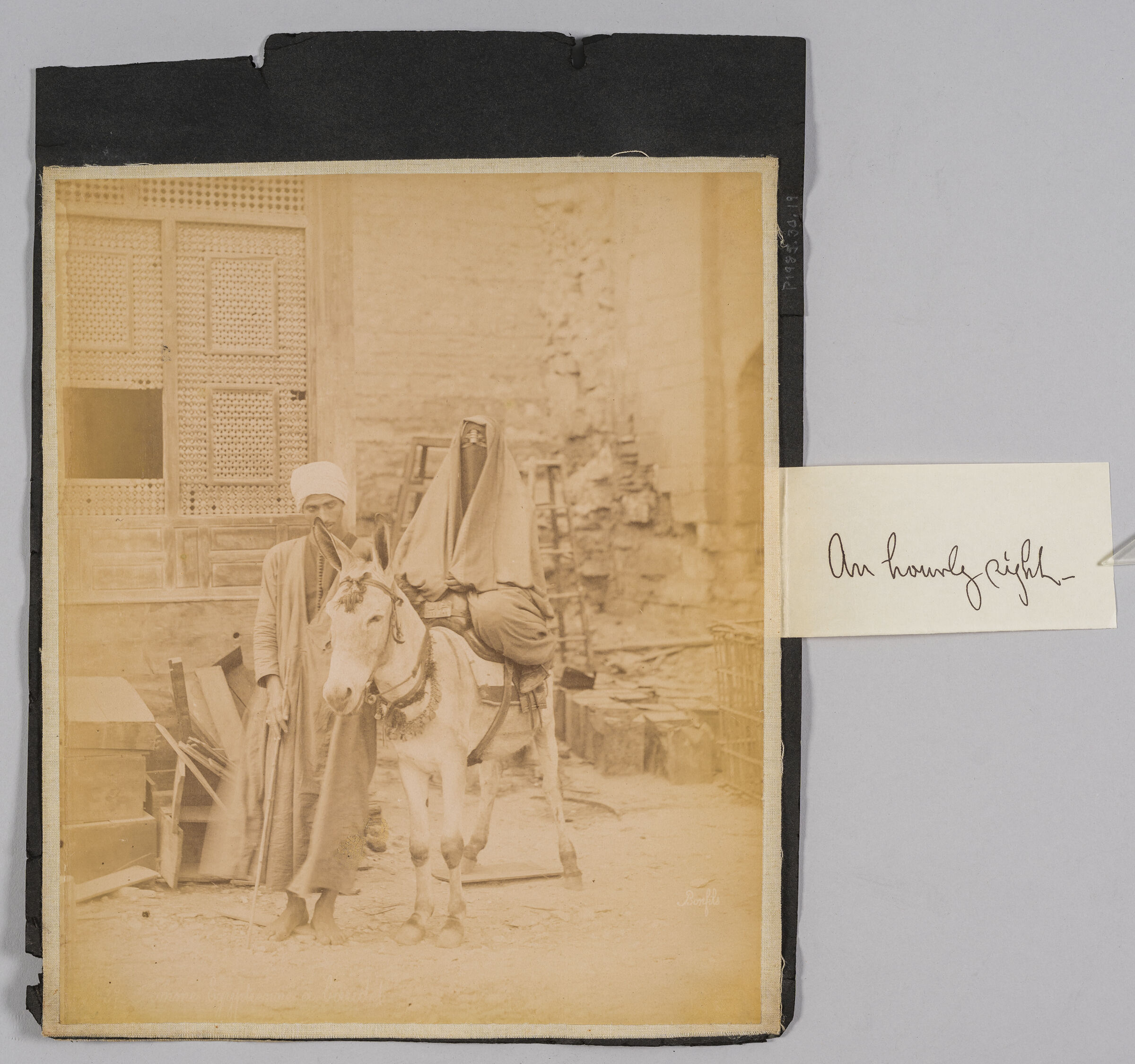 Untitled (Veiled Woman Astride A Donkey Being Led By A Man Wearing A Turban)