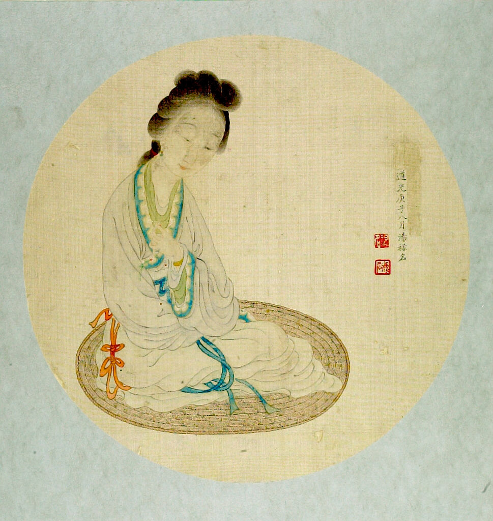 Lady Seated On A Mat Holding A Buddhist Rosary