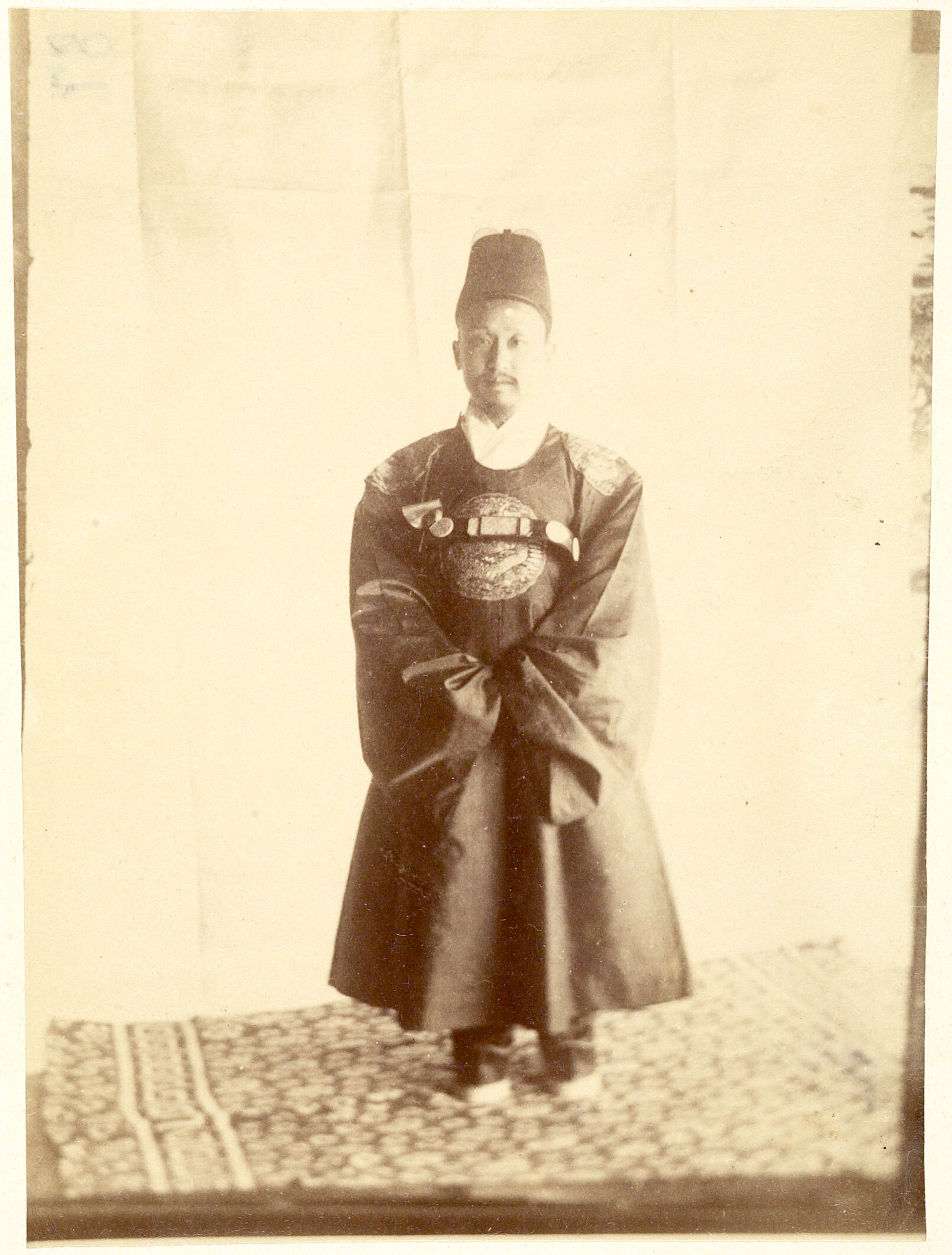 Portrait Photograph Of King Ko-Chong Wearing Royal Robes And Standing On A Carpet