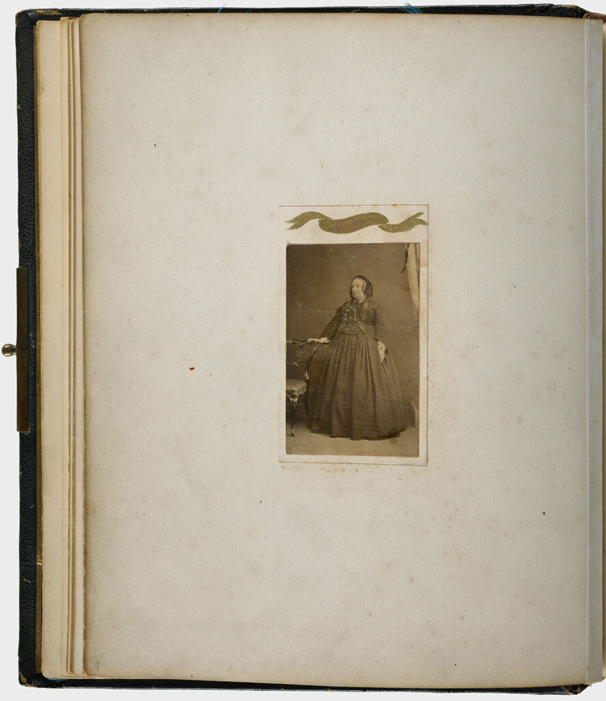 Untitled (Verso: Albumen Silver Print Carte De Visite Photograph, Full-Length Of Woman, Right Hand Resting On Back Of Chair, Labeled Phatty)
