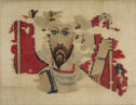 A textile fragment with a red background bearing a woven portrait of a bearded man next to a hand grasping a staff.