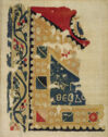 A textile fragment in black, white, yellow, blue and red threads with floral and geometric patterns and an inscription in Greek. 
