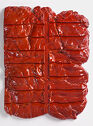 

A bright red, rectangular ceramic relief with horizontal and vertical impressions on the surface. 
 
