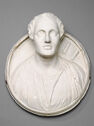 A round marble relief portrays the bust of a man whose head projects outward and upward with great depth.