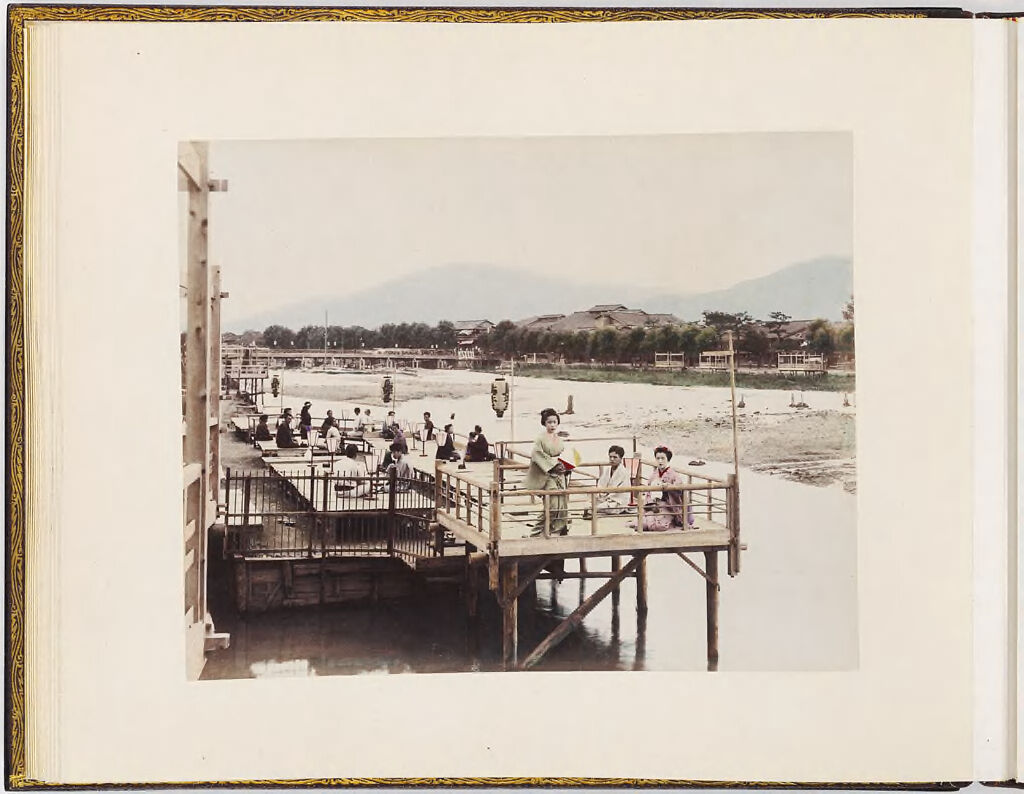 Untitled (Group Of People On Pier, Buildings And Mountains In Background)