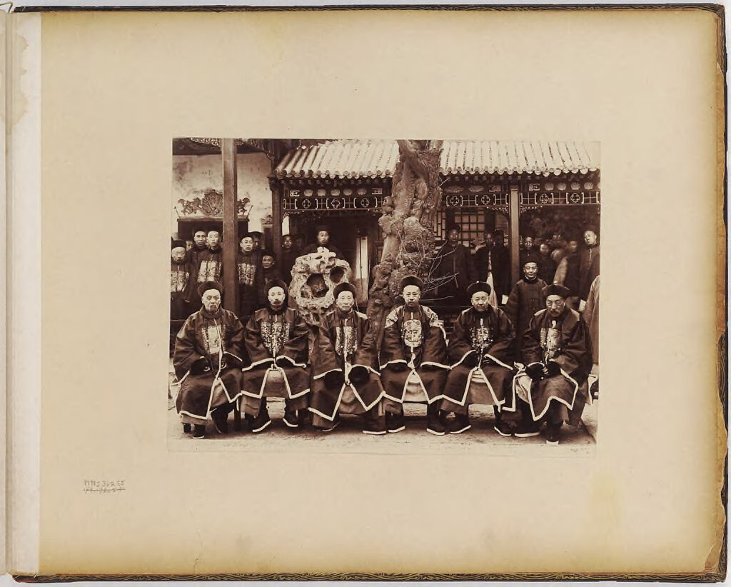Untitled (Group Of Six Men, Seated, Crowd Of Men In Background)