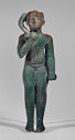 A bronze sculpture of a nearly nude half-seated boy. His right hand is up by his face and he has a curved form hanging at the side of his head.
