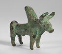 A metal figure of a horned bull with a large hump coming off its back behind its shoulders
