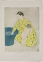 A woman kneels in front of a round blue water filled tub, holding onto a toddler in her left arm.