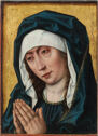 A crying woman visible from the waist up with her hands together.