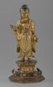 A gilt bronze sculpture of a man standing on a decorated pedestal.