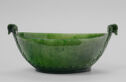 A green jade bowl in the shape of an oval with leaf handles