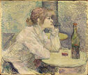 A woman facing right sits at a small table looking straight ahead with a wine bottle in front of her.　