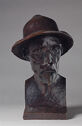 A three-dimensional bronze bust of the artist Pierre-Auguste Renoir wearing a hat.