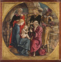 A baby sits on a woman’s lap surrounded by a kneeling man and three standing figures.
