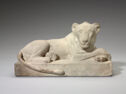 
A limestone statue of a recumbent lion.