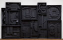 A sculpture of ten connected square or rectangular wooden boxes of different sizes.