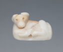 A marble anamorphic form. The bottom of the piece is flat with two visible legs horizontal along the body. The rounded head sits upright and has two shallow holes for eyes. The wide ears on top are round and flat against the head.