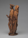 Wooden statue of woman and skeleton standing back to back