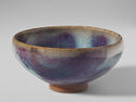 A curved pale teal and purple bowl.